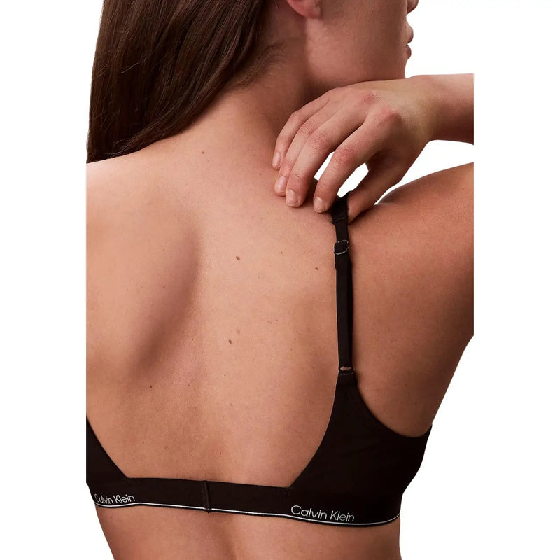 Calvin Klein Jeans Soutien-gorge dos nu noir pour femme, au design minimaliste et élégant, orné d'un discret logo blanc le long de la bande.