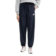 Calvin Klein Jeans womens dark navy blue polyester jogger trousers with drawstring waist, elastic cuffs, and white logo on left thigh