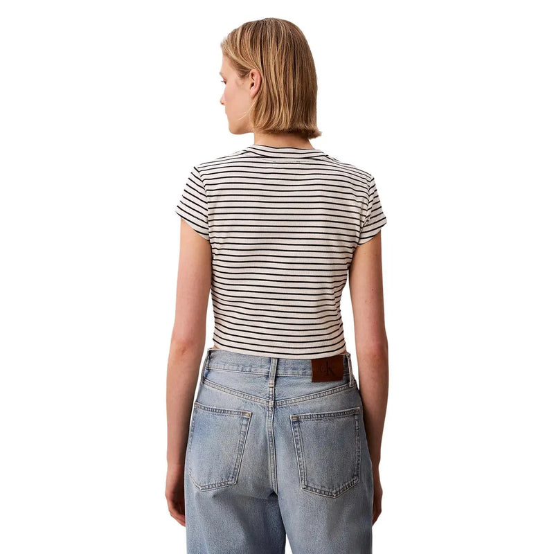 Une femme portant un Calvin Klein Jeans Femme noire à manches courtes, coupe ajustée, rayée, col rond top