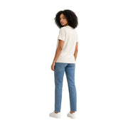 Une femme portant un t-shirt blanc à manches courtes et col rond en coton Calvin Klein Jeans avec un jean bleu clair