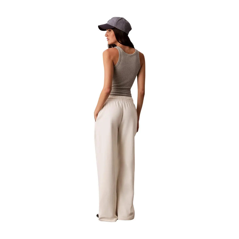 Calvin Klein Jeans Pantalon blanc en coton pour femme avec lacets, en satin crème à jambes larges et taille élastiquée.