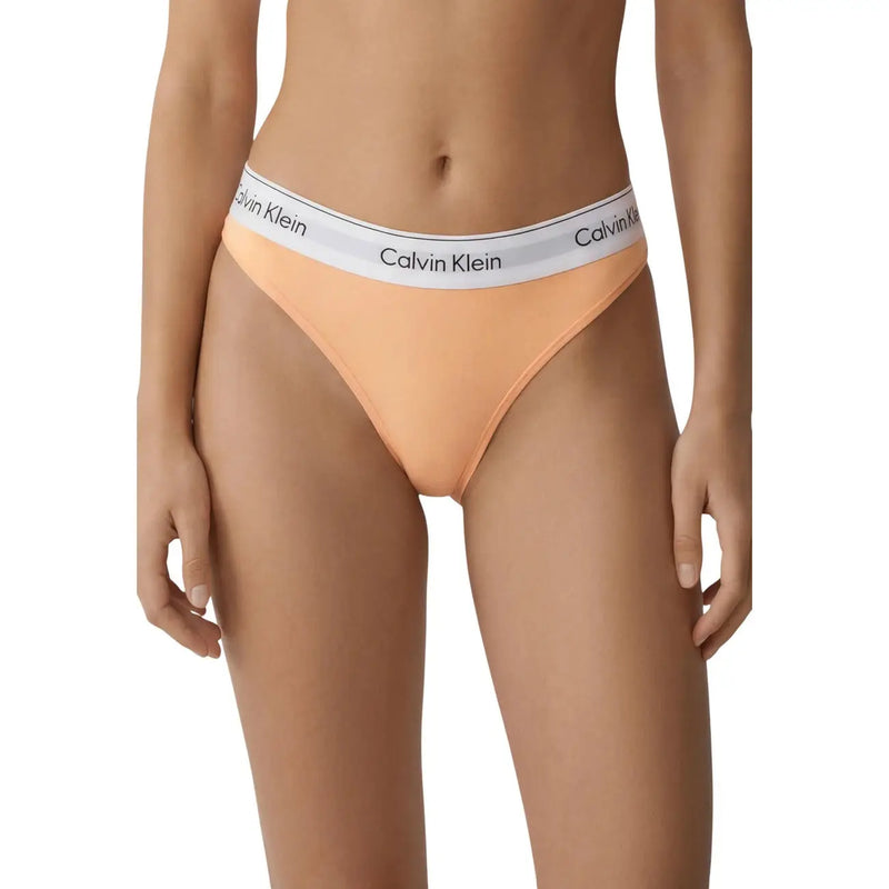 Peach-colored calvin klein jeans women nylon bikini bottom with white branded elastic waistband for brazilian beachwear
