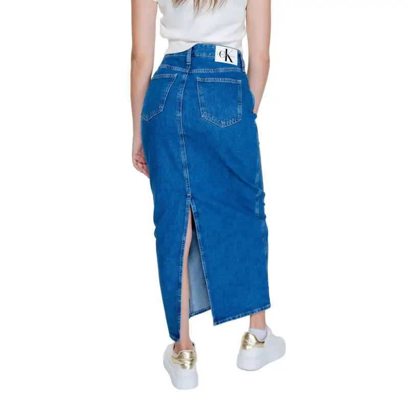 Calvin Klein Jeans women’s blue cotton denim midi skirt with front slit and back pockets features logo patch at waistband