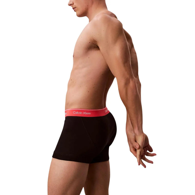 Black calvin klein men cotton trunks with red waistband featuring the brand logo in a 3 pack set