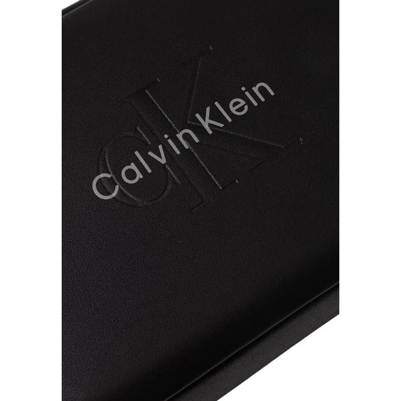 Portefeuille Calvin Klein pour homme, pochette noire en cuir avec logo en relief en polyuréthane, largeur 22 cm.