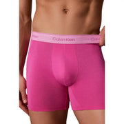 Bright pink Calvin Klein men boxer briefs with matching lavender logo waistband made of soft cotton in a 5 pack