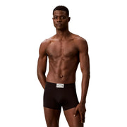 Black calvin klein men’s cotton briefs with white waistband label featured in green cotton trunk underwear product