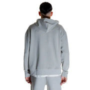 Light gray Calvin Klein men’s full zip hooded sweatshirt with layered white undershirt and sweatpants