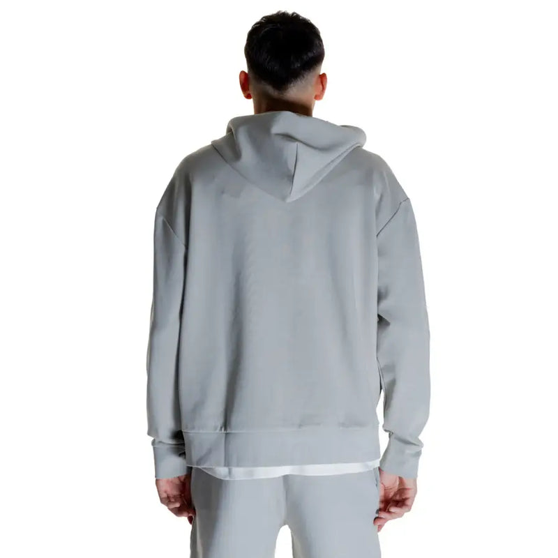 Light gray Calvin Klein men’s full zip hooded sweatshirt with layered white undershirt and sweatpants