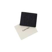Portefeuille zippé en cuir noir Calvin Klein pour homme, orné d'un logo en relief, dimensions : L 7 x H 9 cm