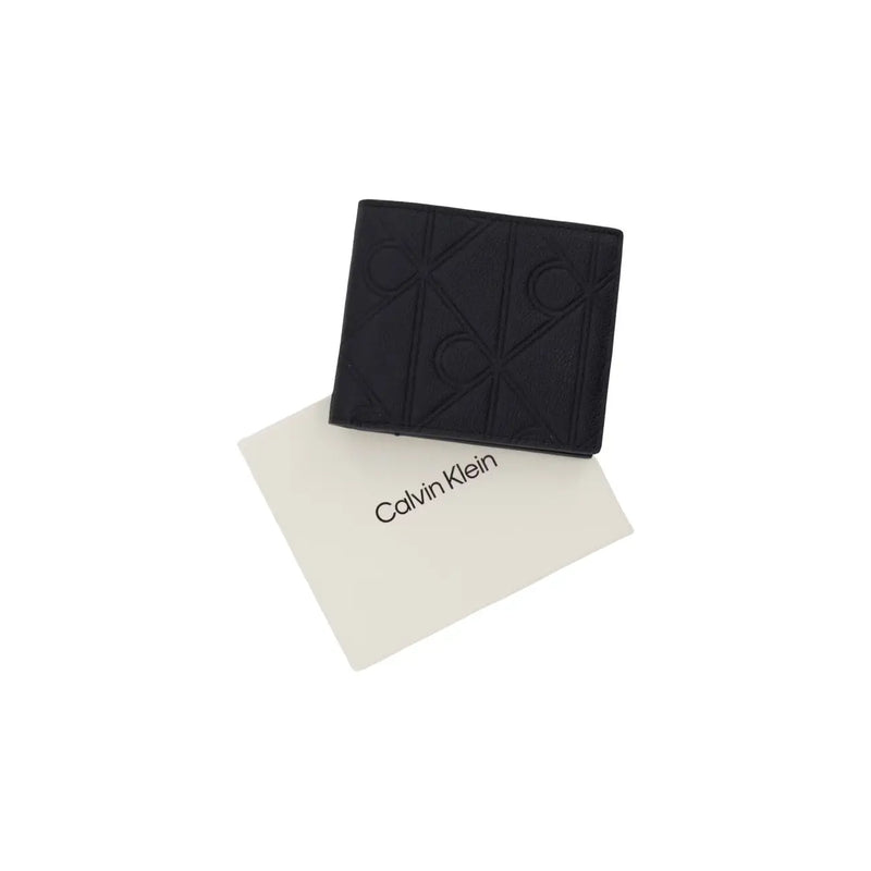 Portefeuille zippé en cuir noir Calvin Klein pour homme, orné d'un logo en relief, dimensions : L 7 x H 9 cm