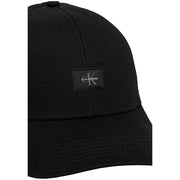 Calvin Klein Casquette trucker homme en coton noir monologo, avec tissu légèrement texturé et petit logo brodé noir.