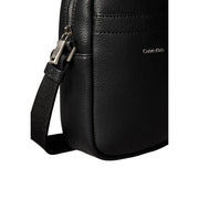 Calvin Klein Sac bandoulière homme en cuir noir texturé avec fermeture éclair argentée et bandoulière réglable