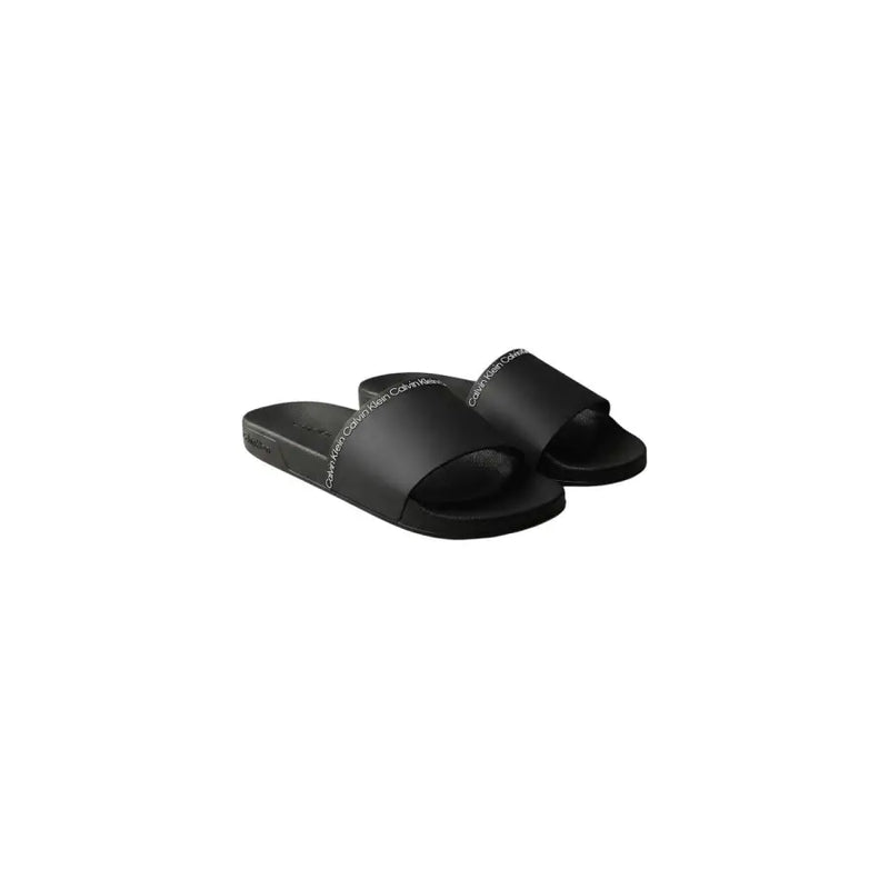 Calvin Klein Sandales mules noires pour homme, à bout ouvert, en polyuréthane élégant avec un discret logo blanc sur la bride.