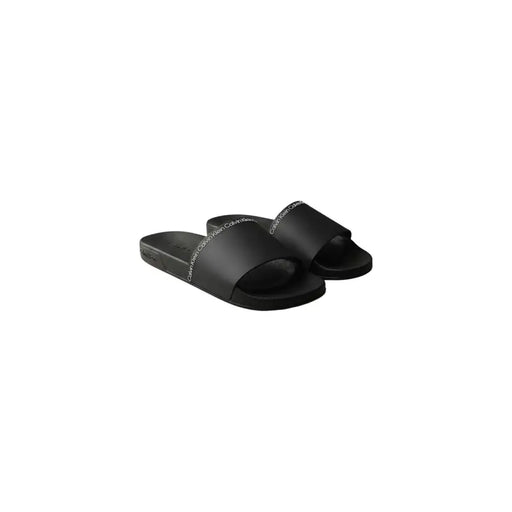 Calvin Klein Sandales mules noires pour homme, à bout ouvert, en polyuréthane élégant avec un discret logo blanc sur la bride.