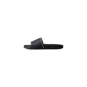 Pantoufles Calvin Klein noires pour homme, sandales plates en polyuréthane à bout ouvert, au design minimaliste et élégant, avec logo blanc.