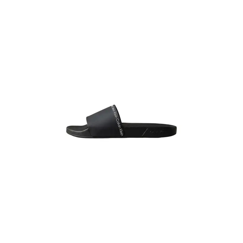 Pantoufles Calvin Klein noires pour homme, sandales plates en polyuréthane à bout ouvert, au design minimaliste et élégant, avec logo blanc.