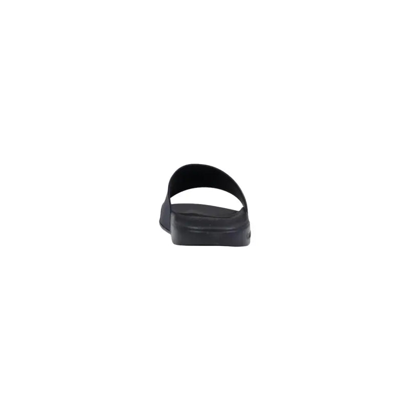 Pantoufles Calvin Klein pour homme, sandales à enfiler en polyuréthane noir au design minimaliste et épuré.