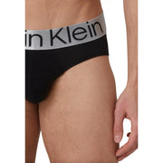 Black Calvin Klein men’s briefs with a gray waistband featuring the Calvin Klein logo in black lettering