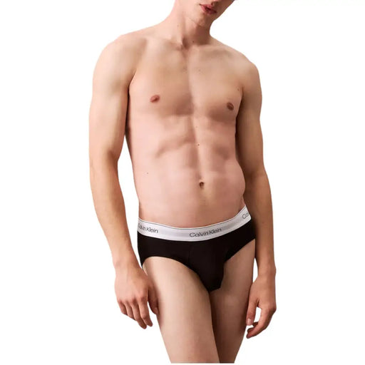 Slip noir Calvin Klein pour homme, avec ceinture blanche ornée du logo Calvin Klein, pour un confort optimal au quotidien.