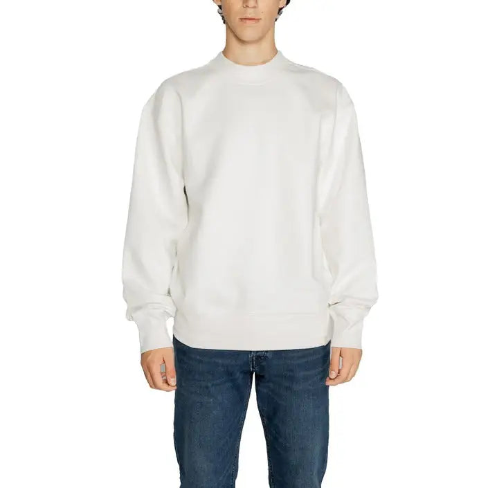 White crewneck sweatshirt worn by a model, showcasing Calvin Klein Men Sweatshirts
