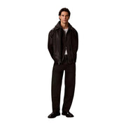 Black leather bomber jacket with hood and front zipper shown with calvin klein mens grey cotton hooded sweatshirt