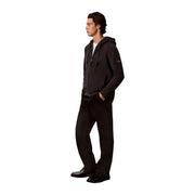 Black zip-up hoodie with a subtle logo patch on the left sleeve for men by calvin klein in cotton material