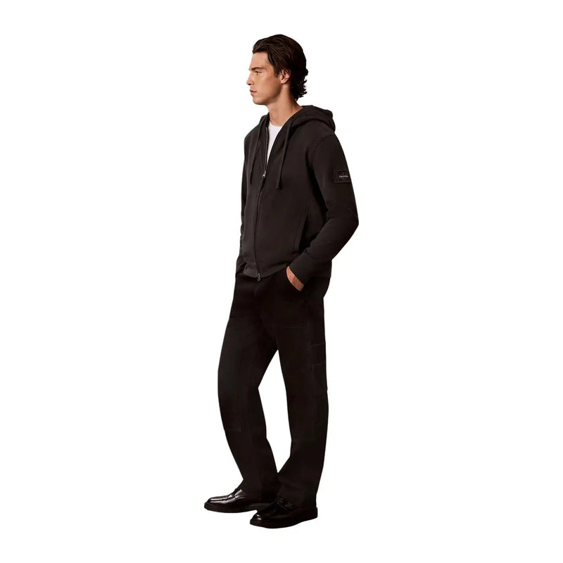 Black zip-up hoodie with a subtle logo patch on the left sleeve for men by calvin klein in cotton material