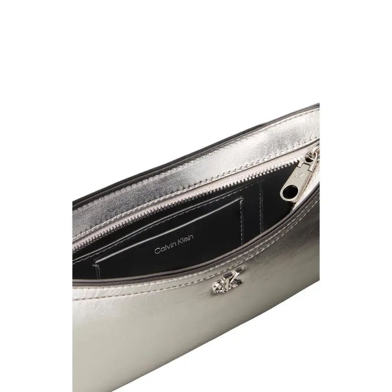 Calvin Klein silver polyurethane handbag with zip pocket featuring metallic belt bag design and black interior lining