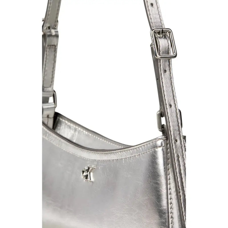 Calvin Klein silver metallic leather shoulder bag with sleek minimalist design and adjustable strap with zip pocket