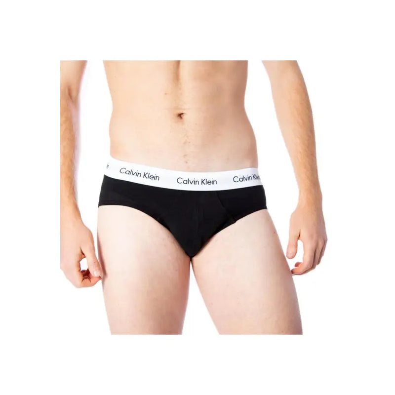 Noir Calvin Klein Slip pour homme avec une ceinture élastique blanche ornée du logo répété de la marque en tissu de coton