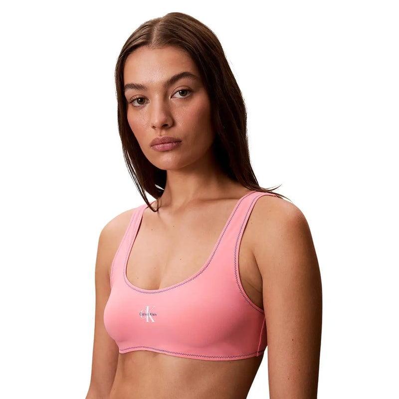 Calvin Klein women beachwear bralette light blue with subtle stitching and small white logo front pink sports bra