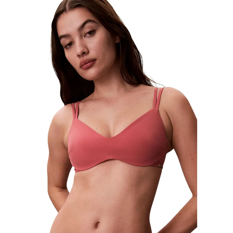 A soft rose-pink seamless underwire bra with thin adjustable straps from Calvin Klein women beachwear bralette collection