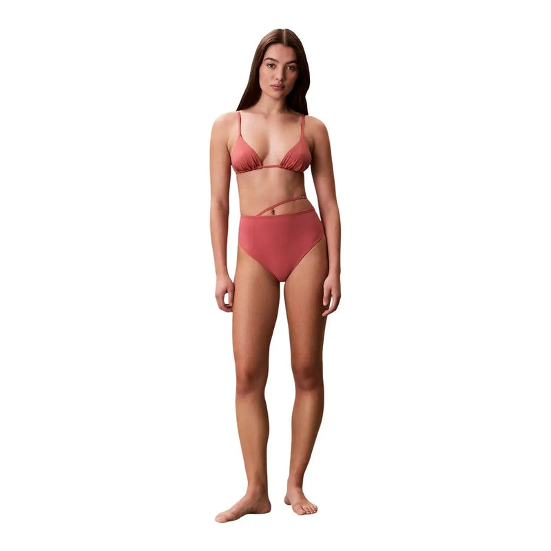 A coral-colored Calvin Klein women beachwear nylon bikini set with a ruched triangle top and side-cutout bottoms