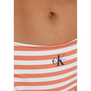 Calvin Klein women bikini bottom in coral and white striped nylon elastane with navy blue CK logo visible from front