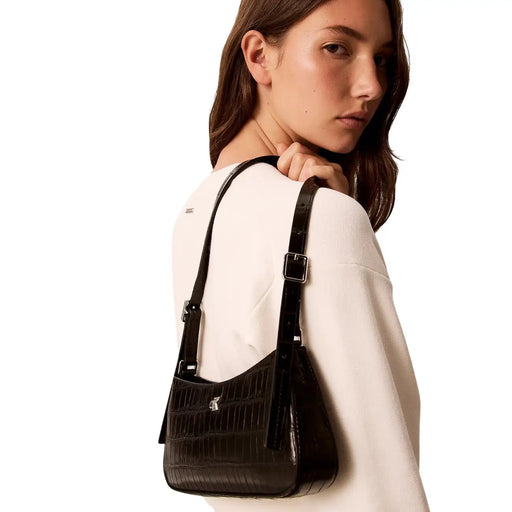 Calvin Klein Sac bandoulière noir pour femme, en polyuréthane à motif crocodile et finitions argentées.