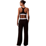 Noir Calvin Klein Pantalon large en jersey de coton pour femme, avec une ceinture élastique blanche ornée du logo de la marque.