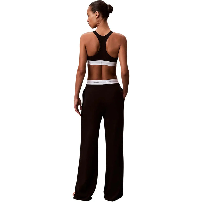 Noir Calvin Klein Pantalon large en jersey de coton pour femme, avec une ceinture élastique blanche ornée du logo de la marque.