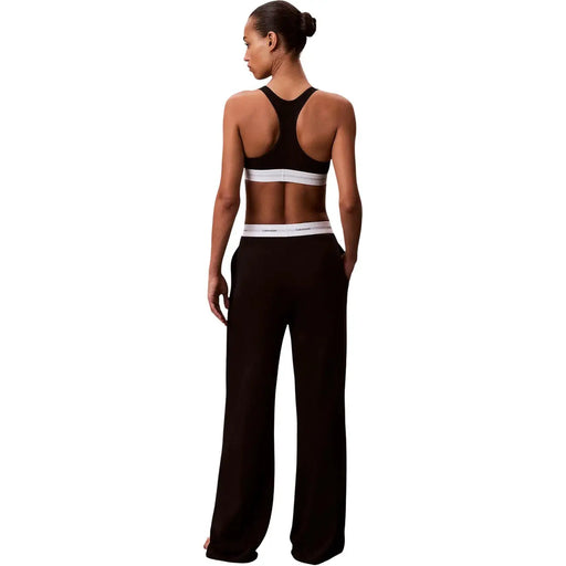 Noir Calvin Klein Pantalon large en jersey de coton pour femme, avec une ceinture élastique blanche ornée du logo de la marque.