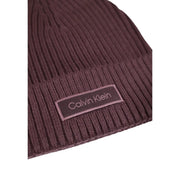 A maroon ribbed knit cotton beanie for women featuring a matching Calvin Klein brand patch