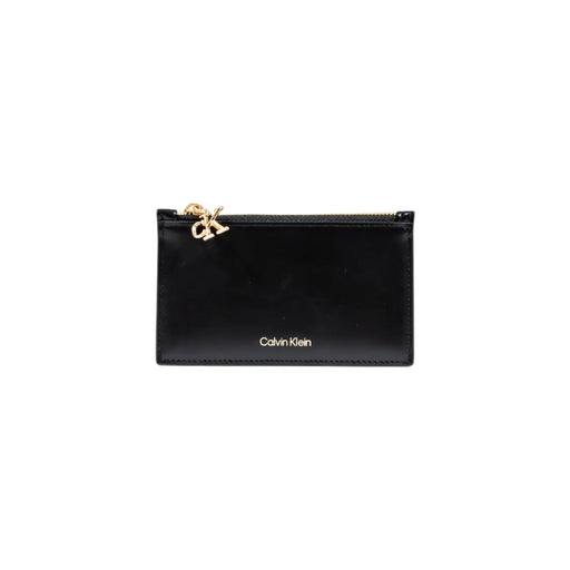 Calvin Klein Portefeuille femme en similicuir noir avec fermeture éclair, porte-cartes orné d'un charm et de surpiqûres CK dorés.