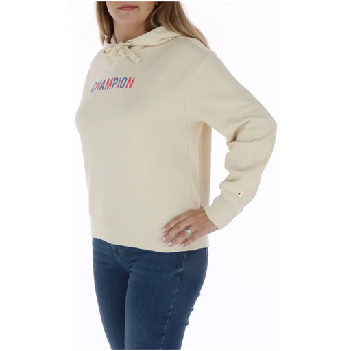 Champion Sweat à capuche beige en coton pour femme, avec une capuche à cordon crème et un logo imprimé rouge et bleu sur la poitrine.