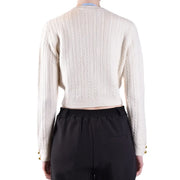 Pull court en maille torsadée couleur crème pour femme, signé Chiara Ferragni, avec poignets à boutons dorés.
