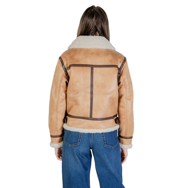 Tan shearling bomber jacket with plush white fleece collar cuffs and dark brown leather trim, paired with beige polyester blazer