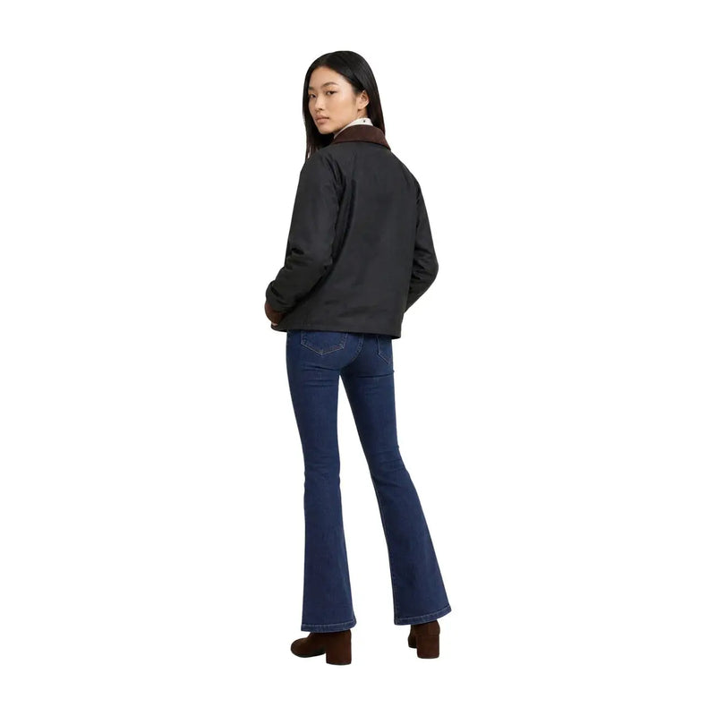 Black jacket with brown shearling collar paired with dark blue flared jeans for a stylish casual look
