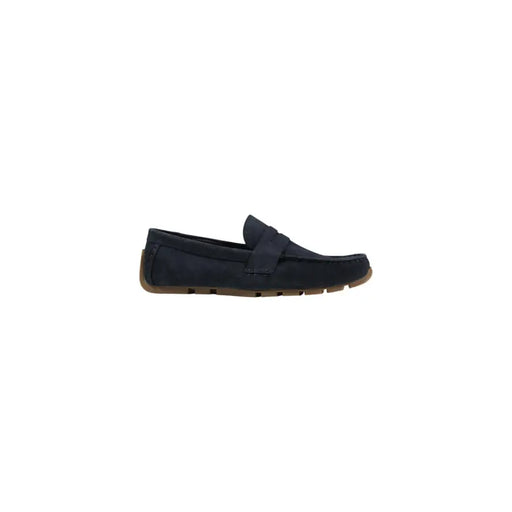 Mocassin Clarks pour homme, en daim bleu marine, avec semelle en caoutchouc beige et détails cousus, idéal pour le printemps et l'été.