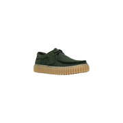 Clarks men slip on shoe in dark green canvas with tan ribbed rubber sole and black laces lightweight fabric design