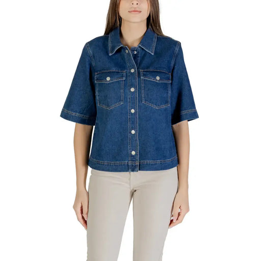 Classic blue short sleeve cotton shirt for women with button-up front, two pockets, and white buttons