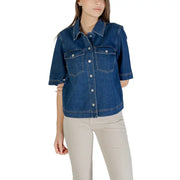 Classic blue short sleeve cotton shirt for women featuring button closures and denim jacket style design