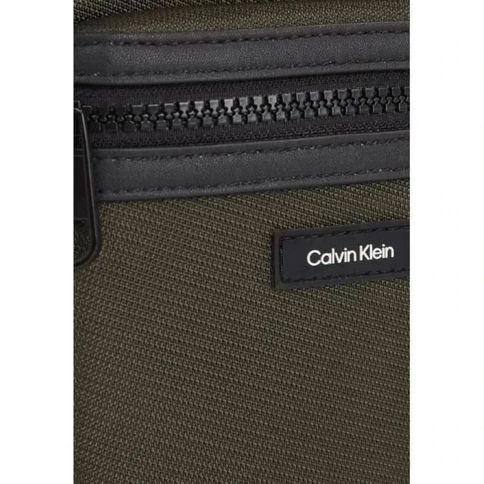 Close-up of a Calvin Klein Men Bag showcasing olive green and black materials with zipper